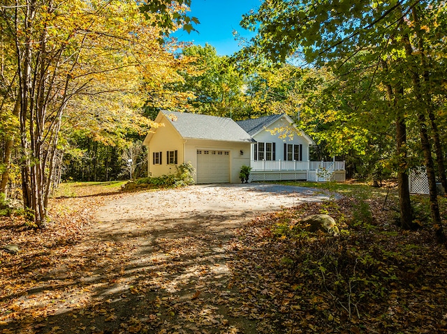 view of front facade featuring covered porch and a garage