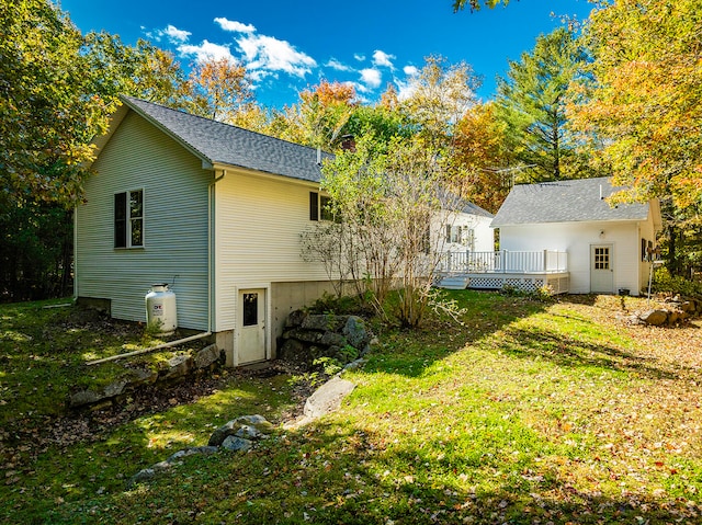 back of house featuring a yard and a deck