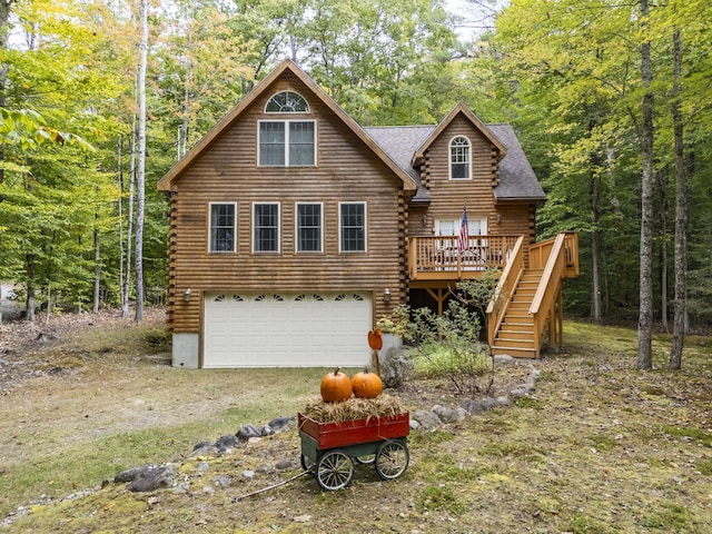 rear view of property featuring a deck and a garage