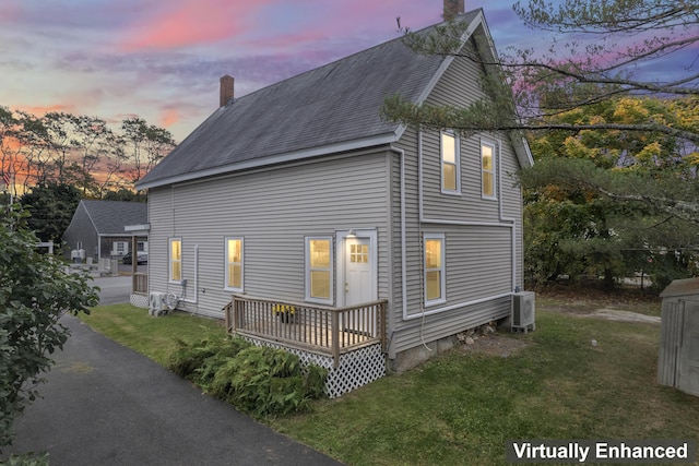5 Harbor Rd, Friendship, ME 04547 - property exterior at dusk with a chimney, a yard, roof with shingles, and a cooling unit