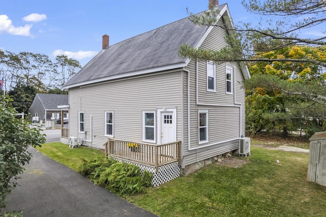 5 Harbor Rd, Friendship, ME 04547 - view of side of property featuring a chimney, a yard, a cooling unit, roof with shingles, and a wooden deck