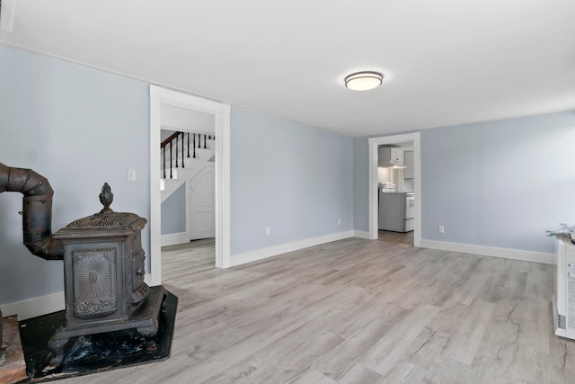 living room featuring light hardwood / wood-style floors and a wood stove