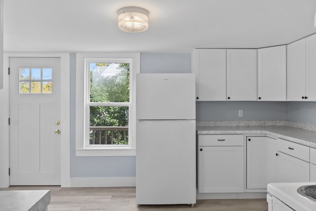 5 Harbor Rd, Friendship, ME 04547 - kitchen with freestanding refrigerator, white cabinetry, plenty of natural light, and light countertops