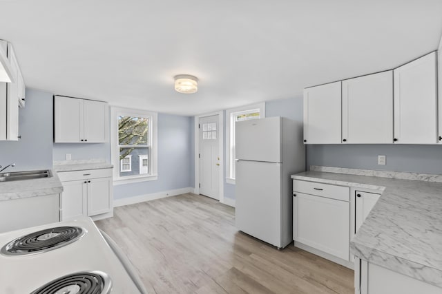 5 Harbor Rd, Friendship, ME 04547 - kitchen featuring freestanding refrigerator, a sink, light wood-type flooring, white cabinetry, and light countertops