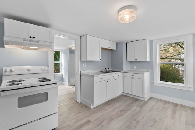 kitchen featuring light hardwood / wood-style flooring, white cabinets, white range with electric cooktop, and sink