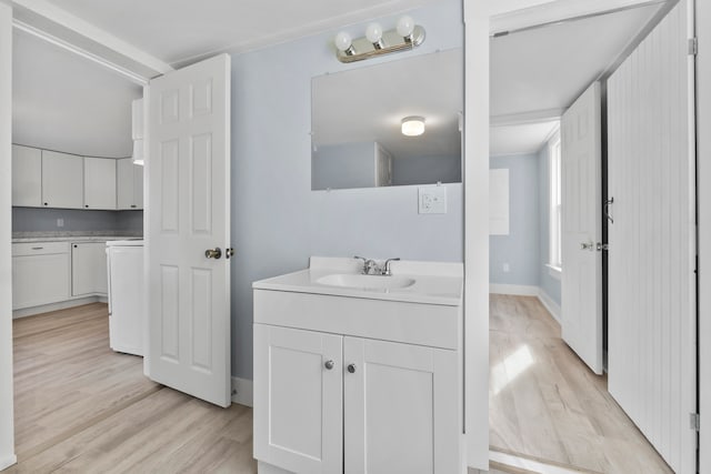 bathroom with hardwood / wood-style flooring and vanity