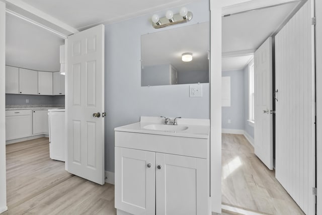 5 Harbor Rd, Friendship, ME 04547 - bathroom with wood finished floors, vanity, washer / dryer, and baseboards