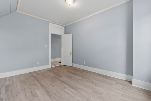 spare room with crown molding and light hardwood / wood-style floors