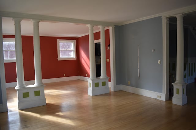 unfurnished living room featuring light hardwood / wood-style floors and ornamental molding