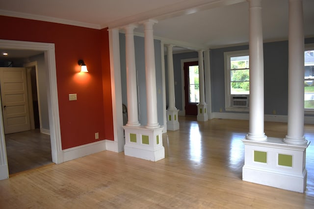 unfurnished living room with crown molding and light hardwood / wood-style floors