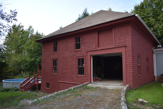 rear view of house with a garage