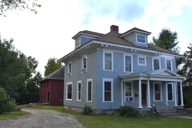 view of front of property with cooling unit and covered porch