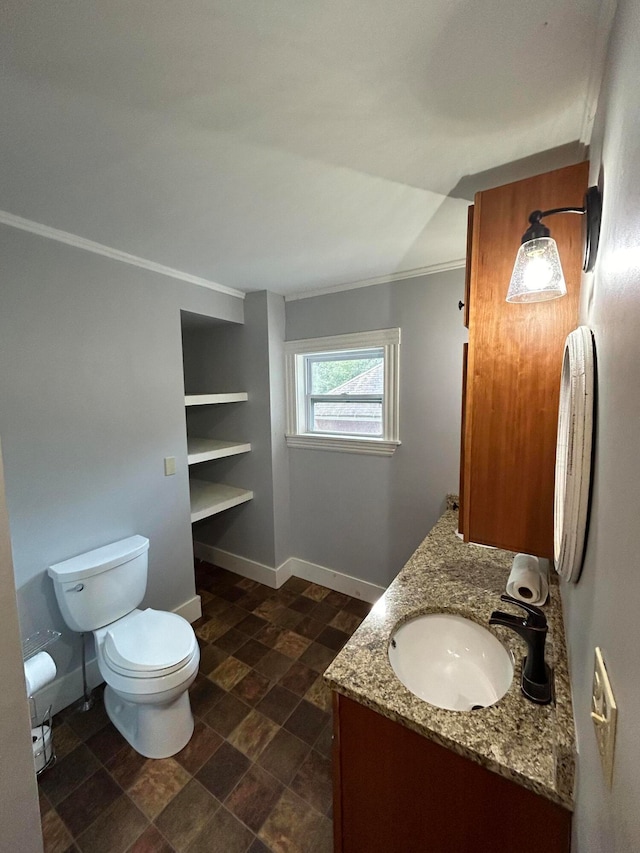 bathroom with vanity, crown molding, and toilet