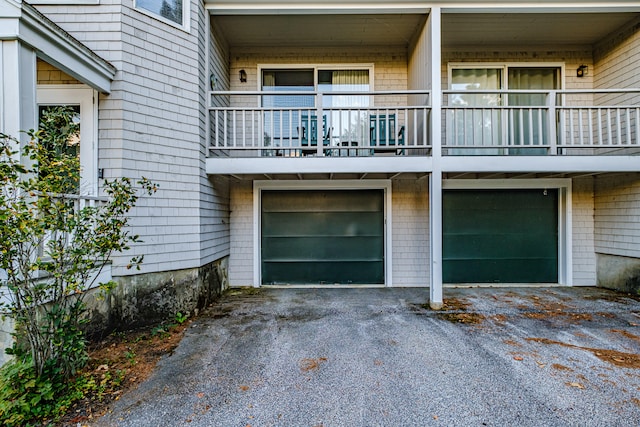 exterior space featuring a balcony and a garage