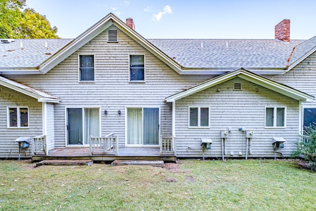 rear view of house featuring a lawn