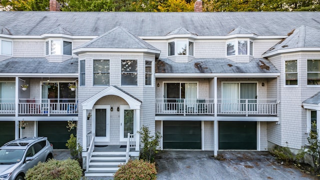 view of front of property with a balcony and a garage