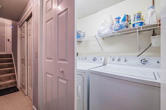 washroom featuring separate washer and dryer and a textured ceiling