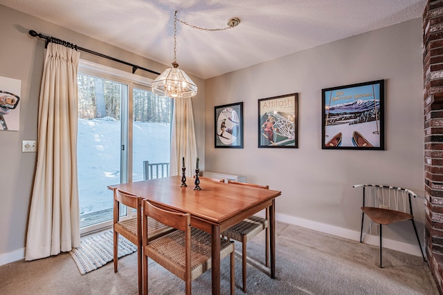 dining area with a notable chandelier, a textured ceiling, and carpet flooring