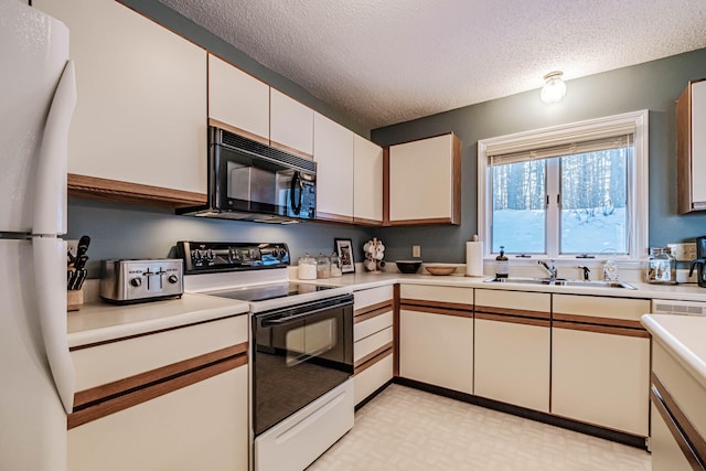 kitchen with white cabinets, white appliances, a textured ceiling, and sink