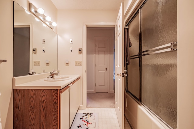 bathroom featuring shower / bath combination with glass door and vanity