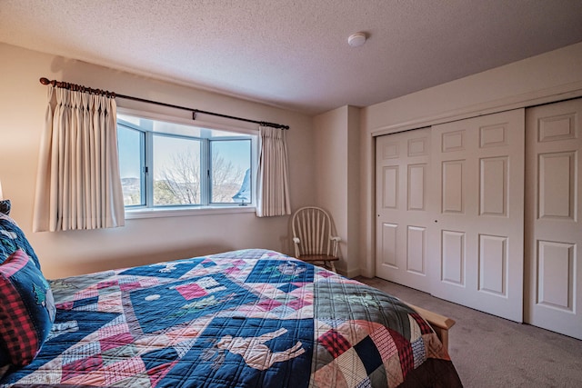 carpeted bedroom with a closet and a textured ceiling