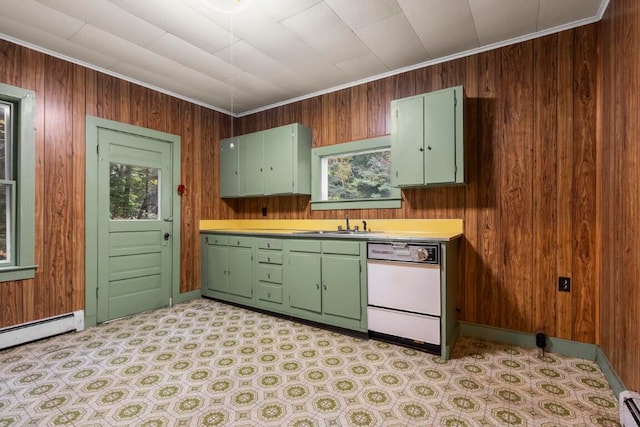 kitchen featuring crown molding, wooden walls, white dishwasher, and a wealth of natural light