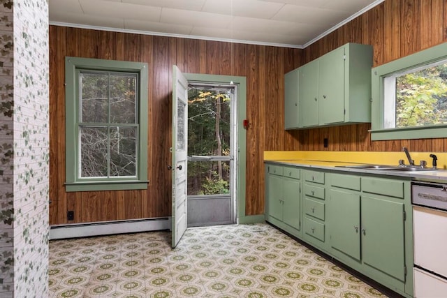 kitchen with wood walls, a baseboard radiator, crown molding, and sink