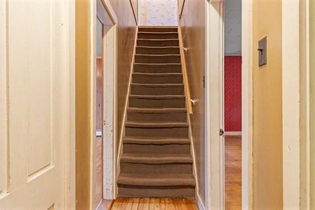 stairs featuring hardwood / wood-style flooring