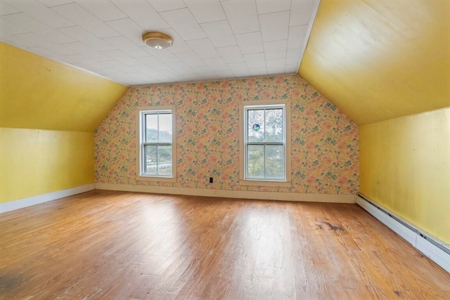 bonus room with hardwood / wood-style flooring, vaulted ceiling, and a wealth of natural light