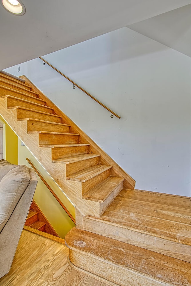 staircase with wood-type flooring