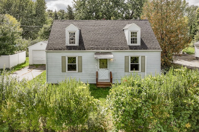 new england style home with an outbuilding and a garage