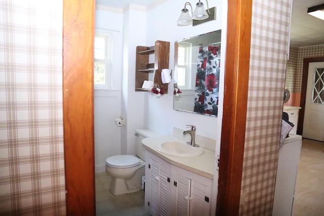 bathroom with vanity, crown molding, and toilet