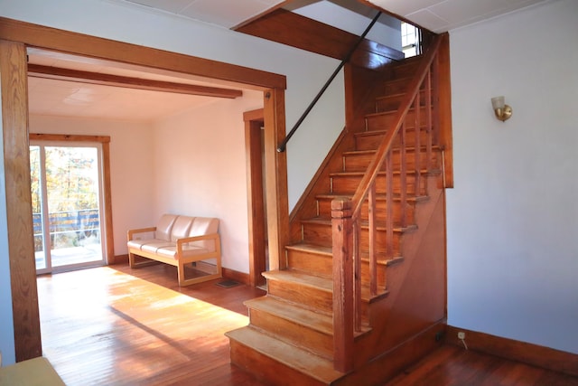 stairs with hardwood / wood-style floors