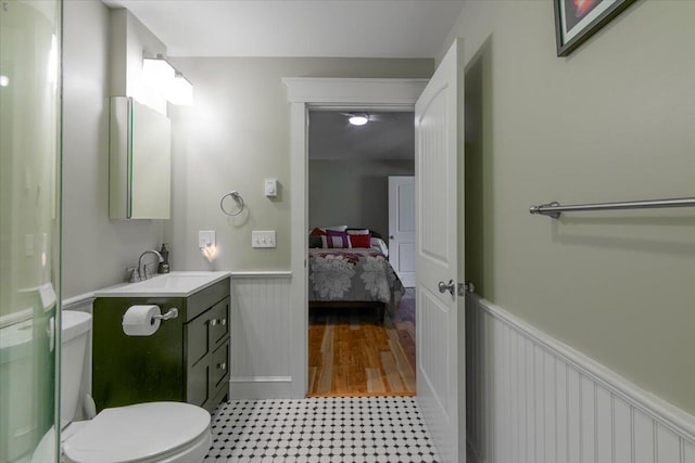 bathroom featuring wood-type flooring, vanity, and toilet