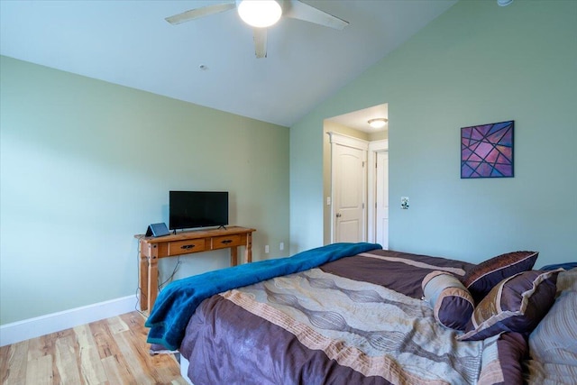 bedroom with light wood-type flooring, vaulted ceiling, and ceiling fan