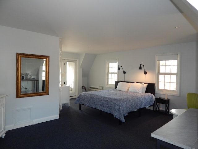 carpeted bedroom featuring multiple windows