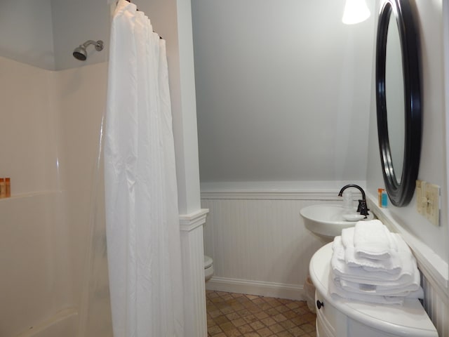 full bathroom featuring shower / bath combination with curtain, sink, and toilet