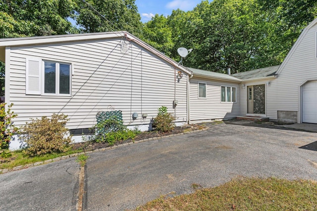 view of property exterior featuring a garage