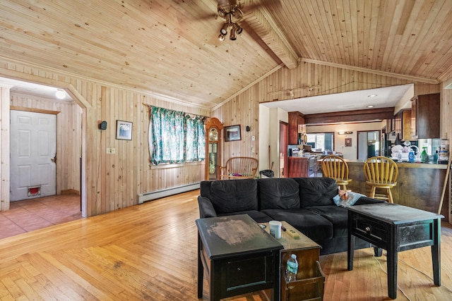 living room with lofted ceiling with beams, baseboard heating, light wood-type flooring, wooden ceiling, and wooden walls