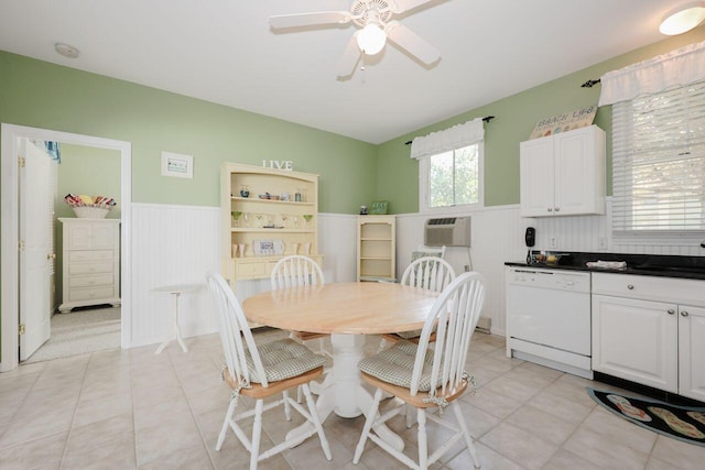 tiled dining area with ceiling fan, a wall mounted air conditioner, and sink