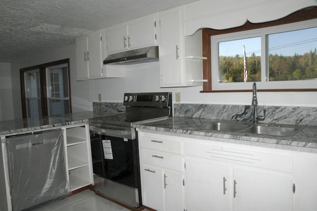 kitchen featuring electric range oven, white cabinetry, a textured ceiling, and sink