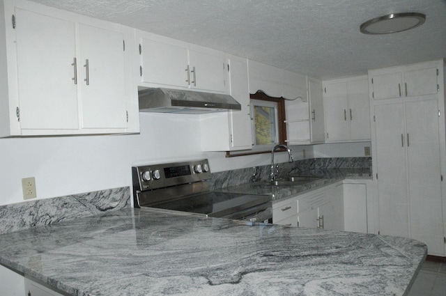 kitchen with white cabinets, a textured ceiling, electric range, and sink