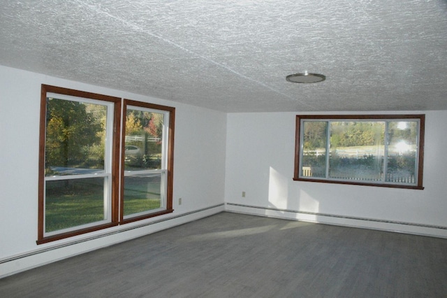 empty room with a baseboard radiator, vaulted ceiling, a textured ceiling, and dark wood-type flooring