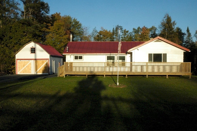 back of house with a storage unit, a wooden deck, and a yard