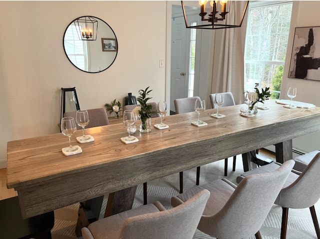 dining space with plenty of natural light and a chandelier