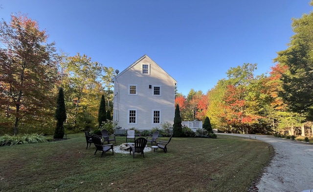 back of property featuring a yard