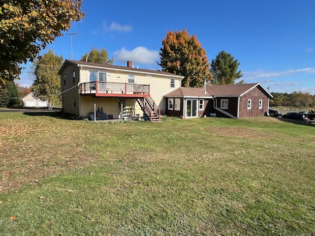 back of house featuring a deck and a yard