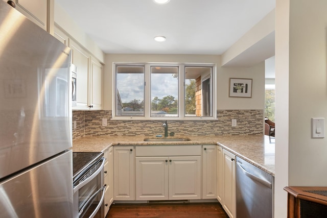 143 Beach Ave Unit 203, Kennebunk, ME 04043 - kitchen with appliances with stainless steel finishes, a sink, decorative backsplash, recessed lighting, and white cabinetry