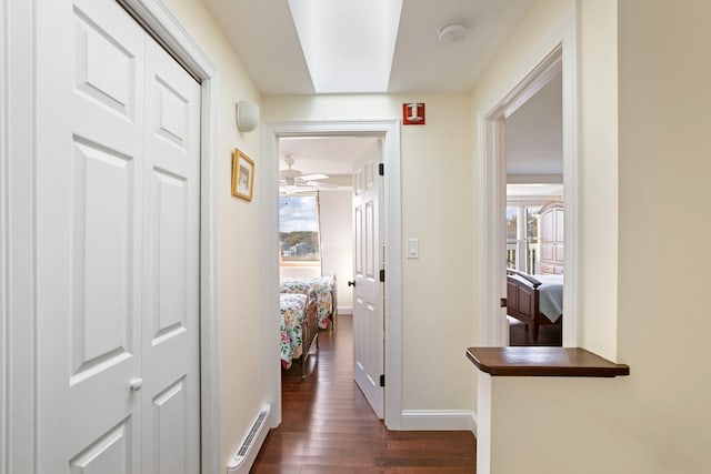 143 Beach Ave Unit 203, Kennebunk, ME 04043 - hallway with dark wood-type flooring, baseboard heating, and baseboards