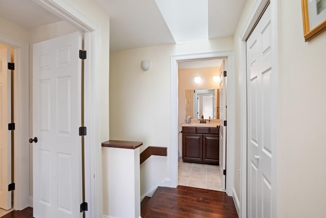 143 Beach Ave Unit 203, Kennebunk, ME 04043 - hallway featuring an upstairs landing, dark wood-type flooring, baseboards, and a sink